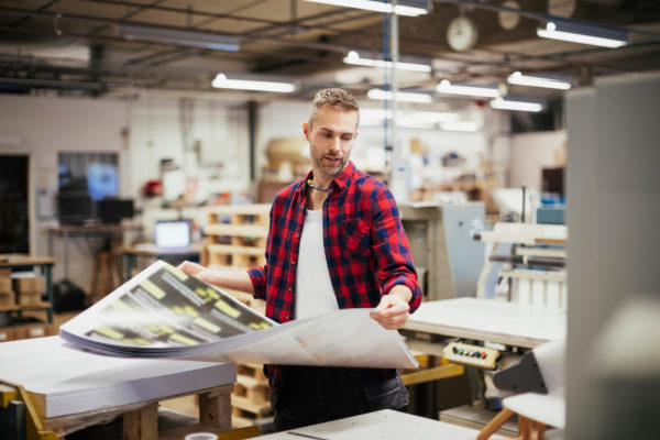 Middle aged caucasian man working in a printing press office